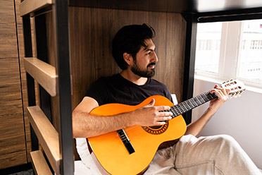 Men on holiday with GUitar